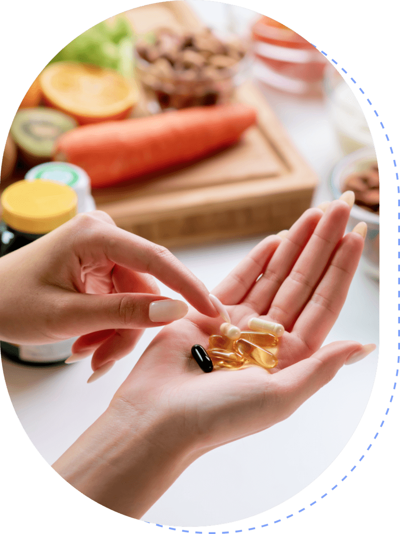 Hands holding vitamin capsules and supplements